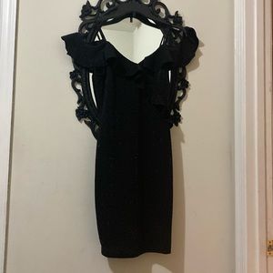 Beautiful mini black dress with sparkles of sequins .